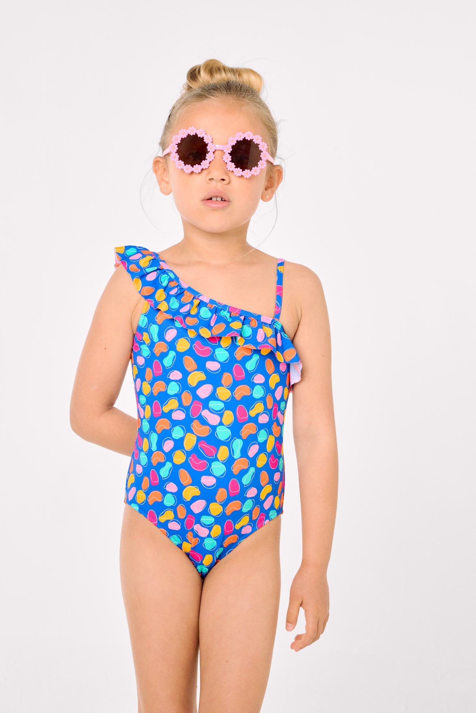 Asymmetrical swimsuit for girls with ruffle detail and organic-shaped print cut-out