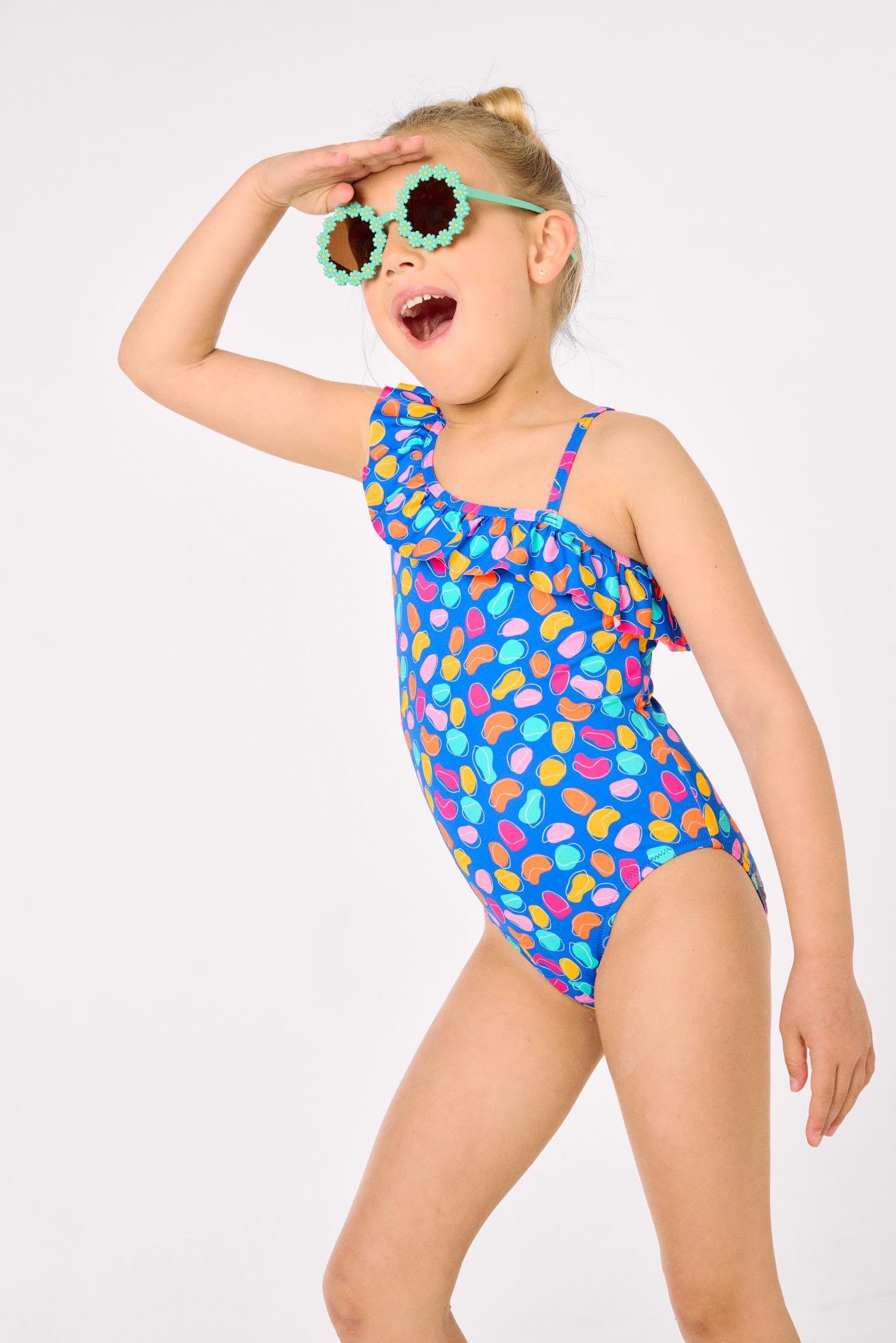 Asymmetrical swimsuit for girls with ruffle detail and organic-shaped print cut-out