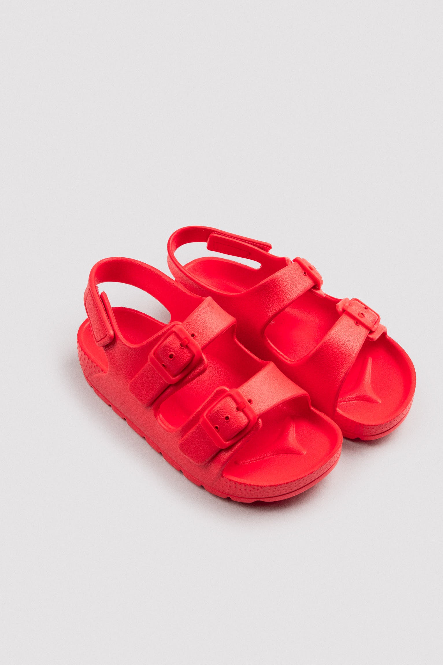 Children's flip-flops with adjustable buckles and red velcro