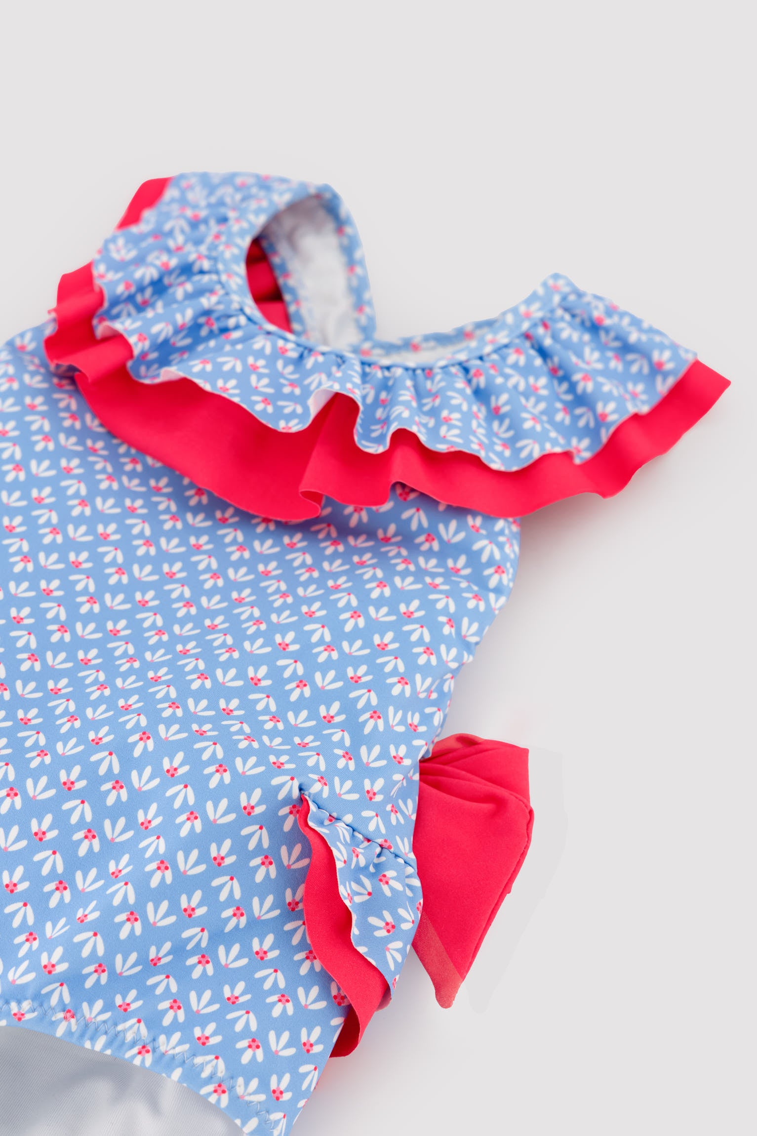 Baby girl swimsuit with ruffle and bow details, floral print