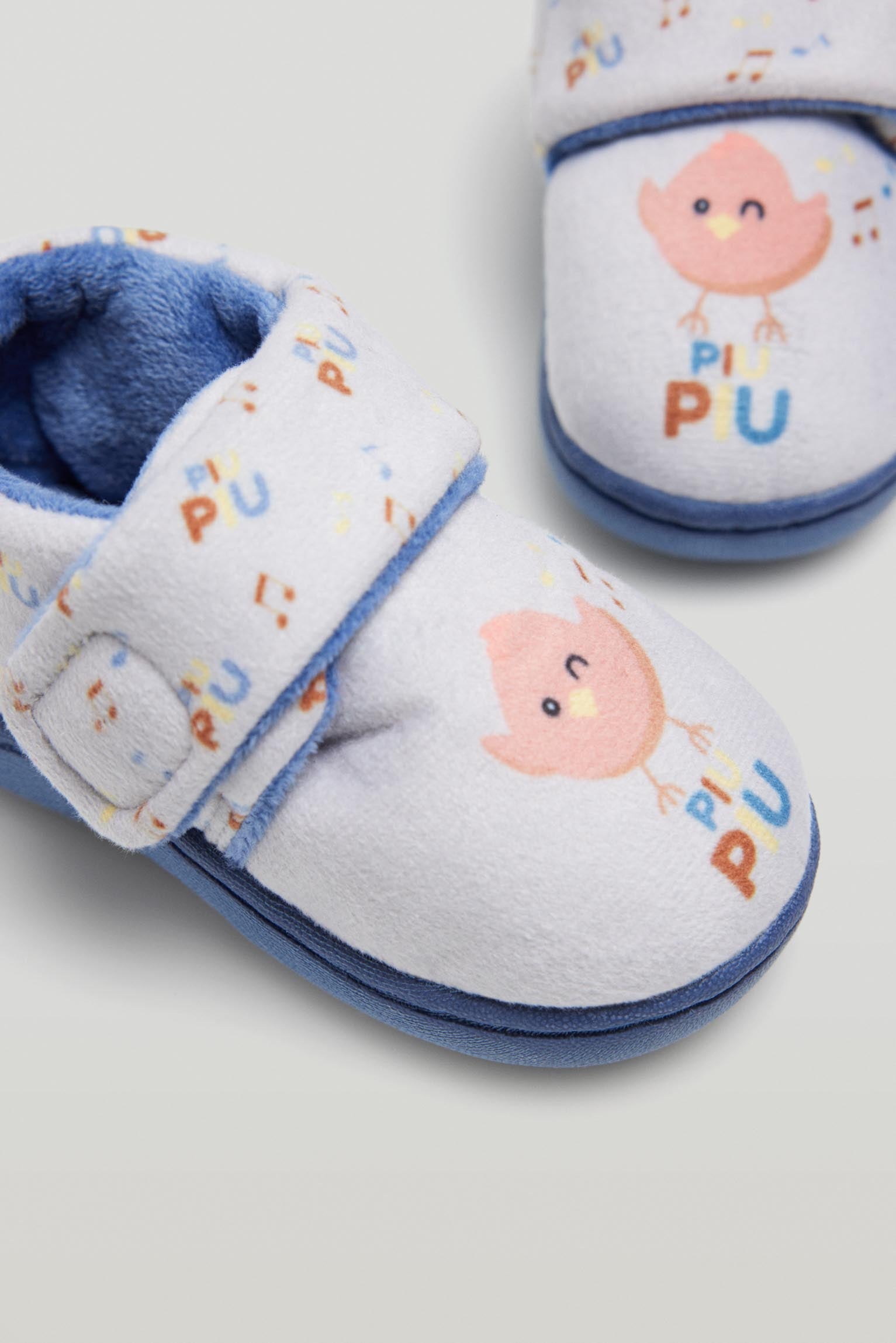 Baby house slippers with adhesive closure