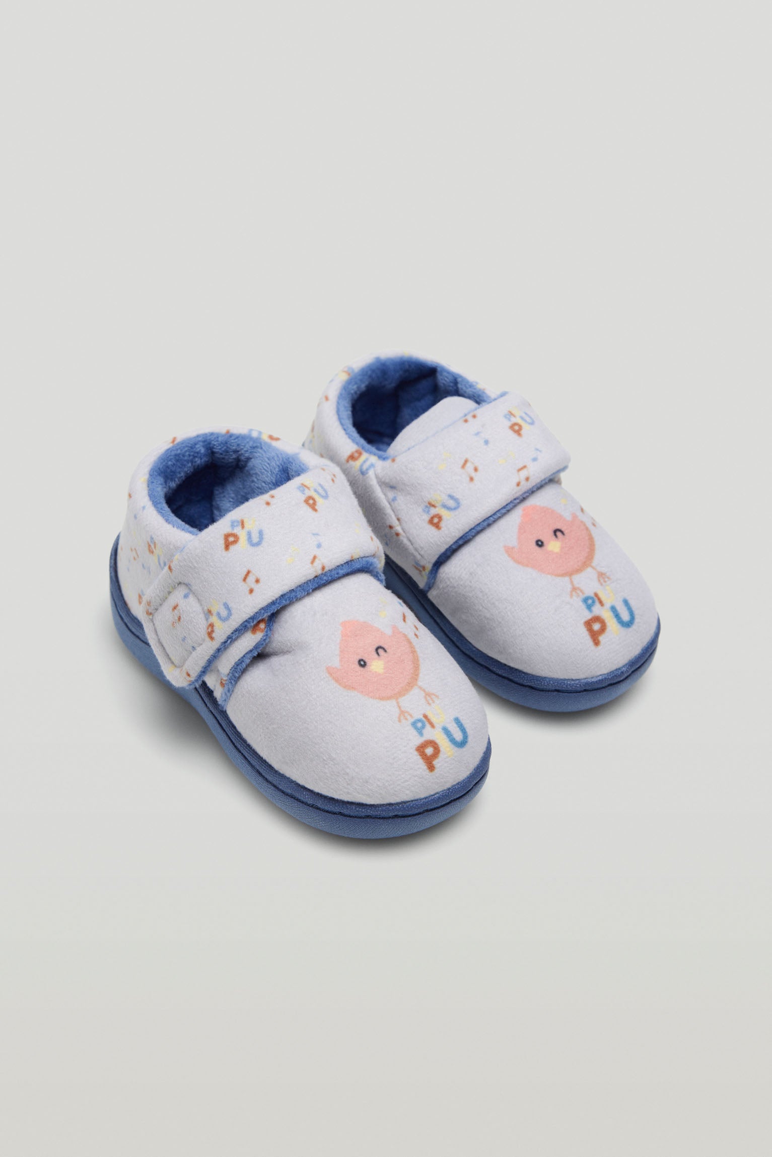 Baby house slippers with adhesive closure